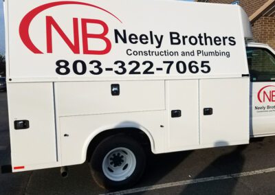 Neely Brothers Construction and Plumbing | white business truck with logo